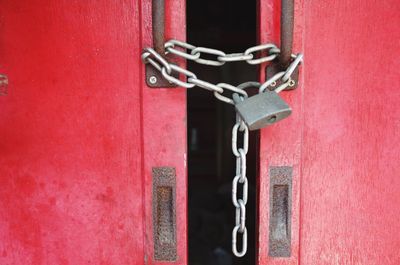 Close-up of padlock on red door