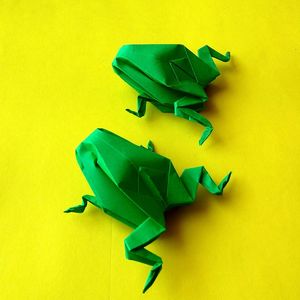 Close-up of multi colored paper against yellow background