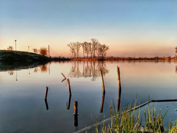 Scenic view of lake against sky at sunset