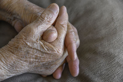Cropped image of senior woman with hands clasped