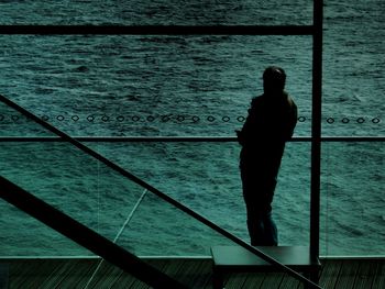 Man standing on railing