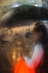 Reflection of woman on wet window