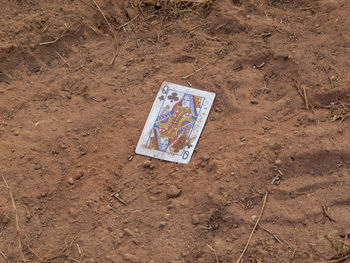 Close-up of paper on sand