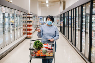 Woman wearing mask shopping at store