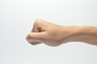 Close-up of hand against white background