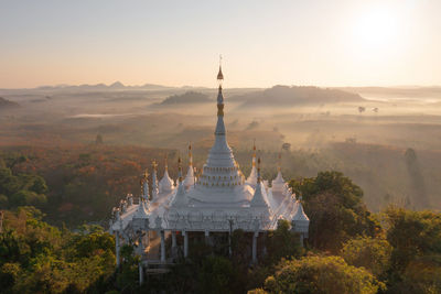 Traditional building against sky during sunset