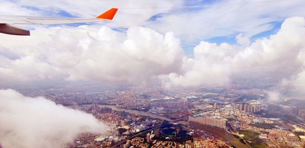 Aircraft landing in moscow through fluffy clouds
