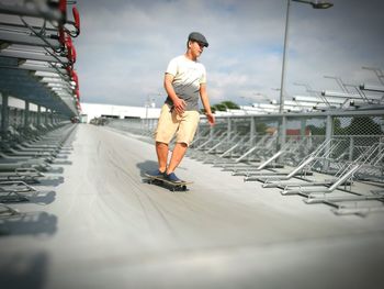 Full length of boy skateboarding at park