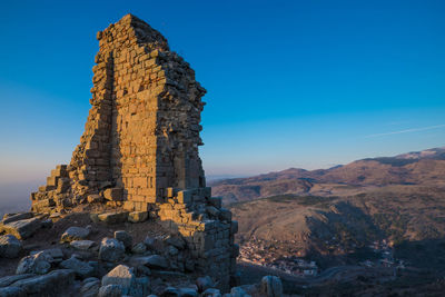 View of rock formation against blue sky