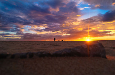 Scenic view of beach against sky during sunset