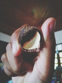 Close-up of hand holding food at home