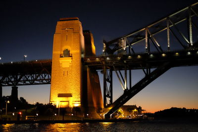 Low angle view of suspension bridge at night