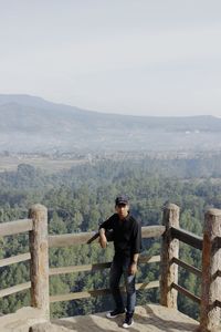 Full length of man standing on mountain against sky