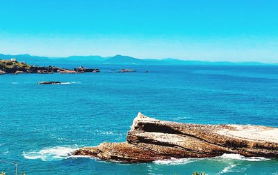 Scenic view of sea against blue sky