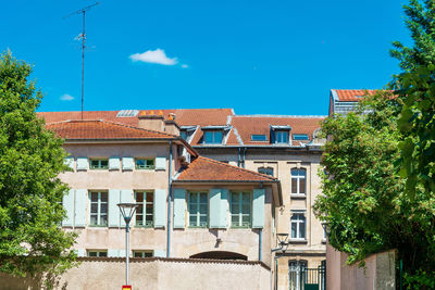 Buildings in city against blue sky