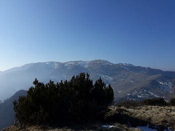 Scenic view of mountains against clear blue sky