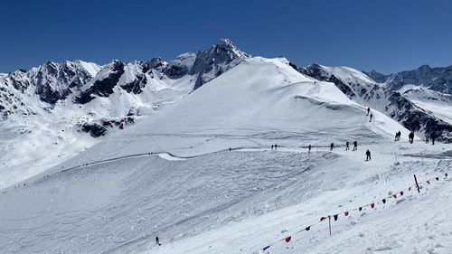 Scenic view of snowcapped mountains against clear blue sky