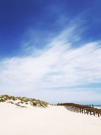 Scenic view of beach against blue sky