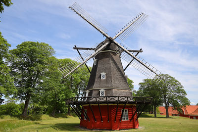 Low angle view of traditional windmill against sky