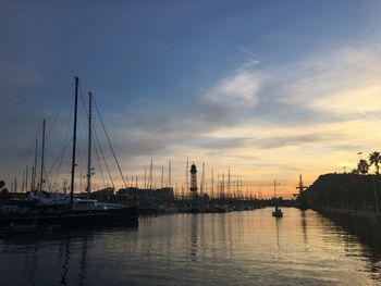 Sailboats in marina at sunset