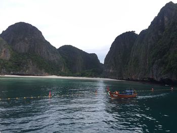 Scenic view of sea and mountains against sky