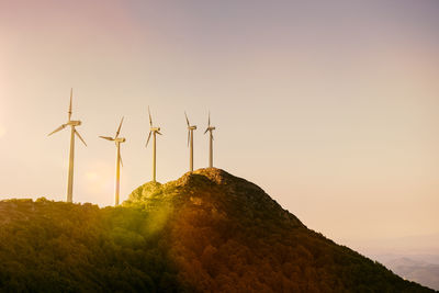 Renewable energy, wind energy with windmills at sunset