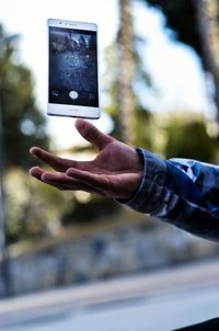 Close-up of hand holding mobile phone