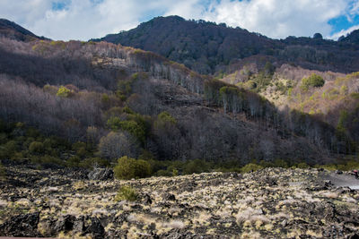 Scenic view of land and mountains against sky