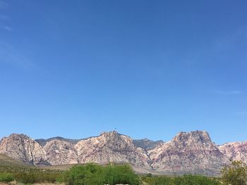 Scenic view of mountains against clear blue sky