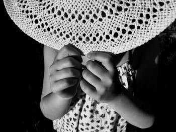 Girl holding hat in darkroom