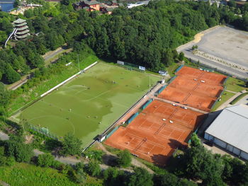 High angle view of tennis court and soccer field