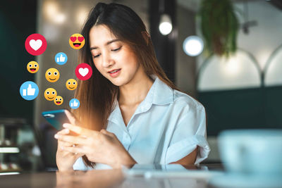 Young woman looking away while using mobile phone