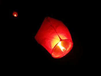 Close-up of light bulb over black background
