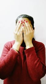 Low section of person standing against white background