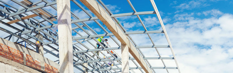 Low angle view of construction site against sky