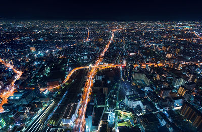 High angle view of illuminated city buildings at night