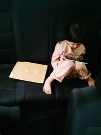 Girl sitting on sofa at home