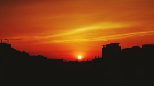 Silhouette of built structures at sunset