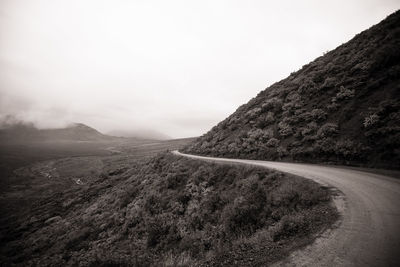 Scenic view of mountain road against clear sky