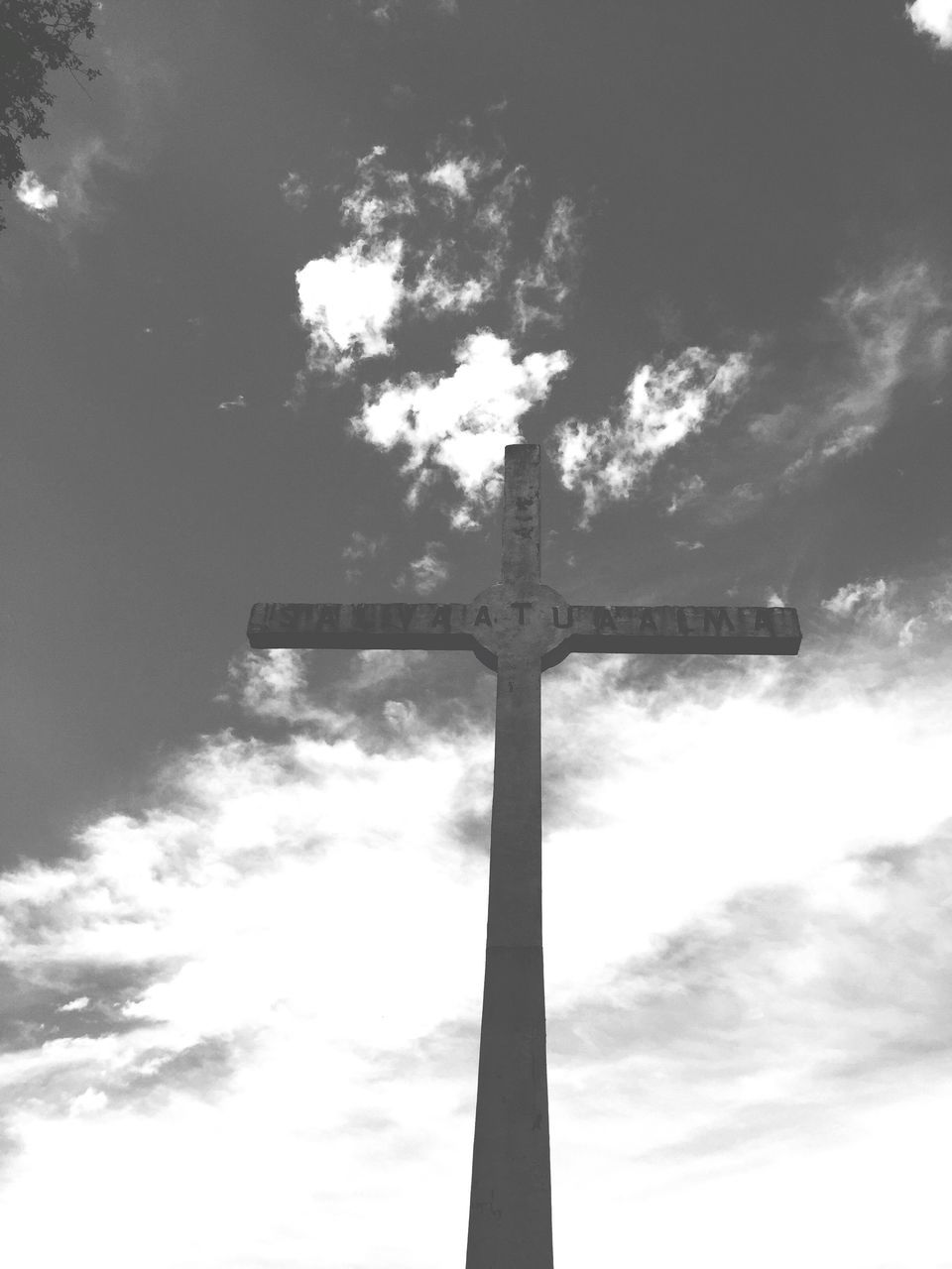 low angle view, sky, cloud - sky, pole, street light, tree, communication, cloud, lighting equipment, silhouette, cloudy, outdoors, no people, day, nature, tall - high, sunlight, cross, guidance, text