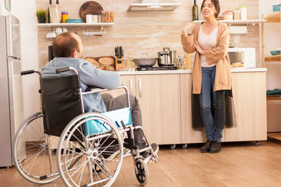 Rear view of couple sitting on floor