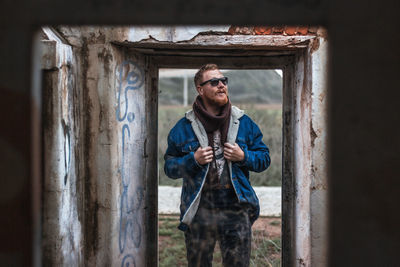 Close-up of man standing against wall