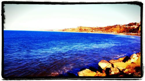 Scenic view of sea against blue sky