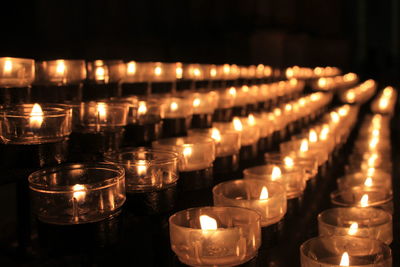 Close-up of illuminated candles in temple