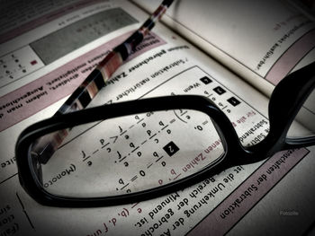 High angle view of eyeglasses on book