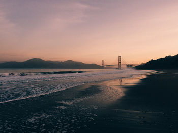 Scenic view of beach against sky during sunset