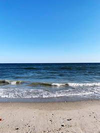 Scenic view of sea against clear blue sky