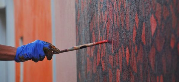 Man working on wood against wall