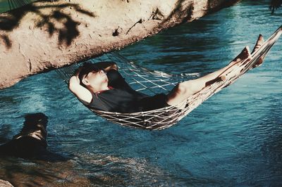 High angle view of woman relaxing on boat in sea