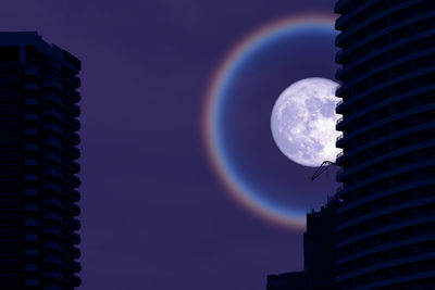 Low angle view of buildings against sky at night